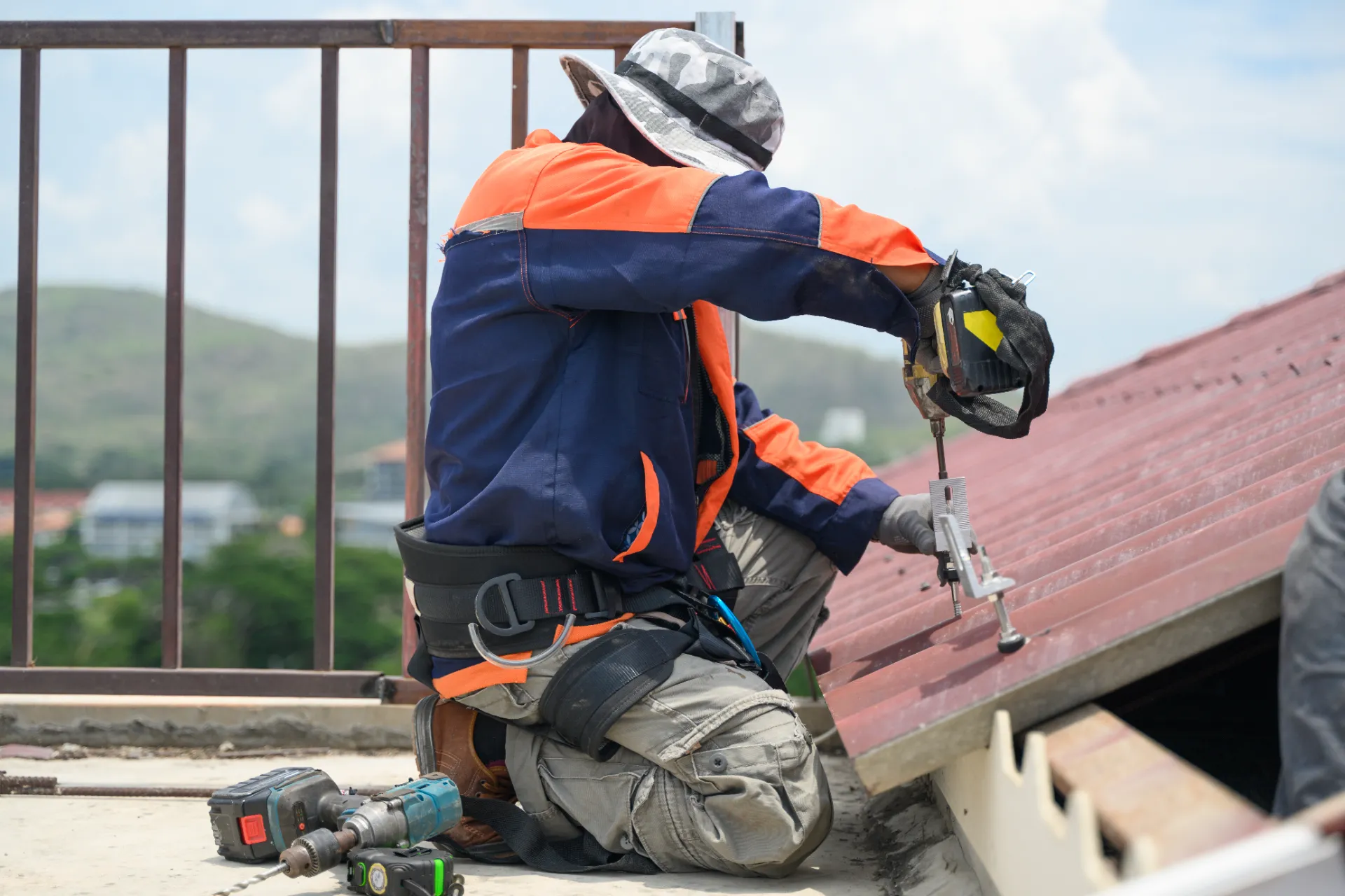 Roofer inspecting shingles for damage