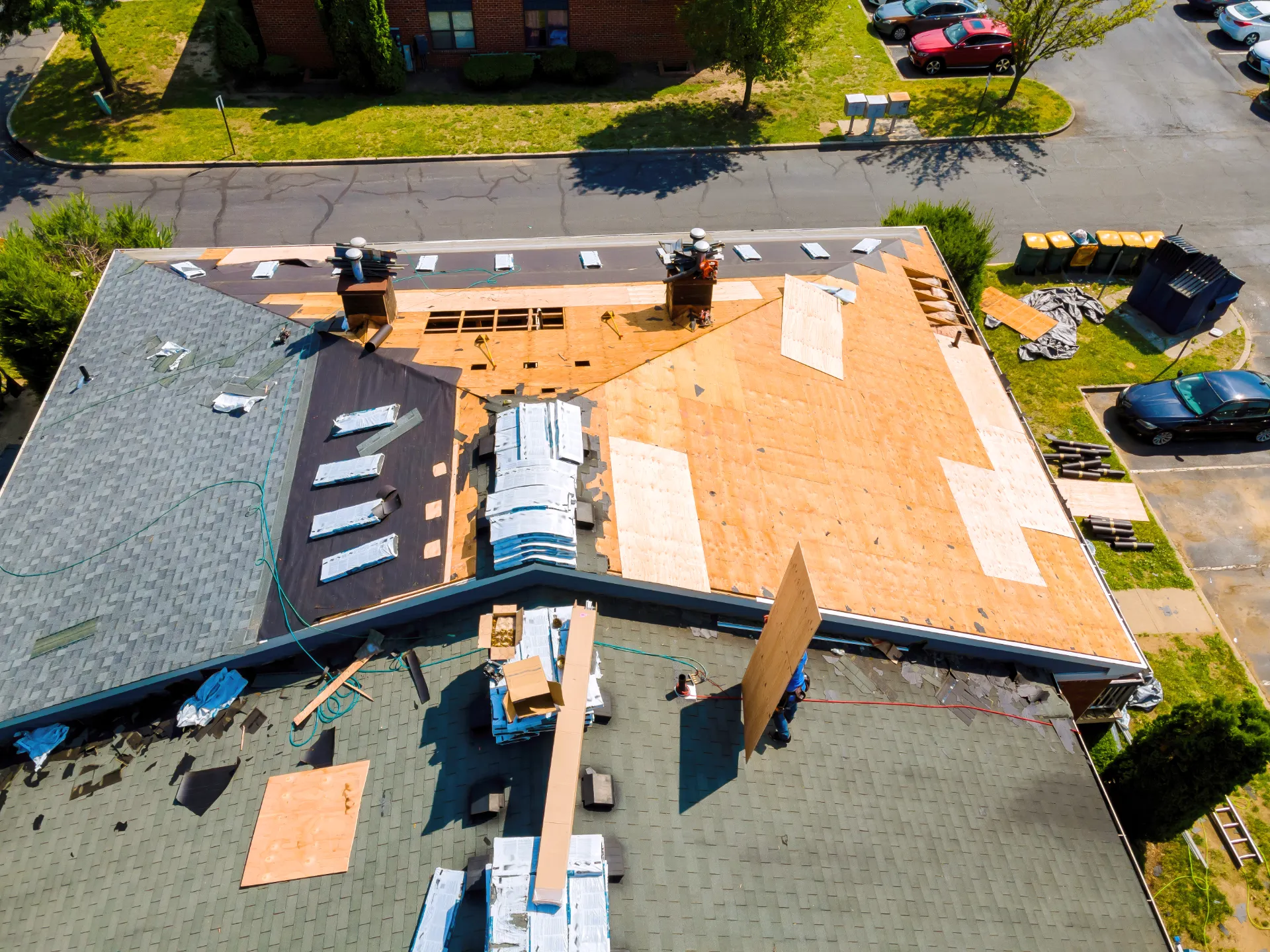 Roofer inspecting shingles for damage